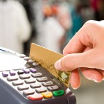 close-up-of-hand-holding-plastic-card-in-payment-machine