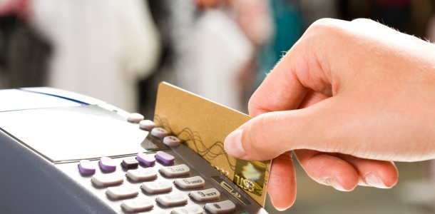 close-up-of-hand-holding-plastic-card-in-payment-machine