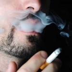 man-smoking-in-dark-with-visible-smoke