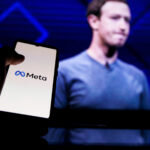 meta-logo-on-screen-and-mark-zuckerberg-is-a-chief-executive-officer-of-metaverse-in-background