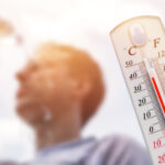 man-pouring-water-on-his-head-in-extreme-heat-thermometer-in-summer-day-shows-or-indicate-high-temperature