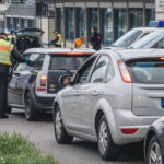 wide-image-of-police-officer-inspecting-car-at-border-crossing-in-kehl-from-france